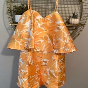 Orange romper with zip up closure! Size L from these three boutique